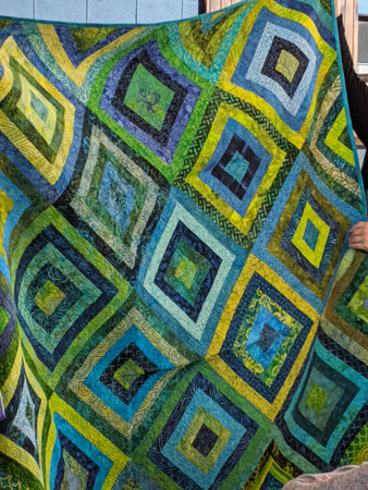 Two examples of the many very attractive quilts Amy showed us.