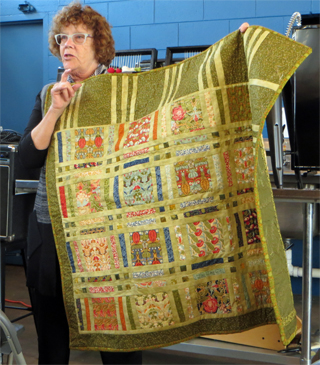 She also brought a quilt she had made using Voysey fabric squares. In the photo on the right she showed us its quilted back.