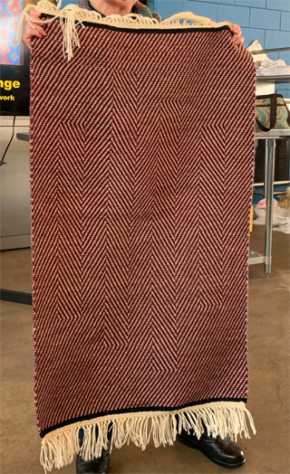 Above are two of the three Collingwood wool rugs Kathy wove, each with a different op-art effect