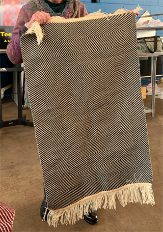 Above are two of the three Collingwood wool rugs Kathy wove, each with a different op-art effect