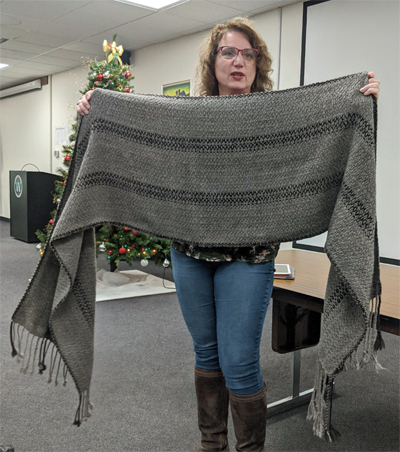 Lisa, with the Christmas tree in the background, showed us four pieces she had woven, including the alpaca shawl on the left and the llama scarf on the right. Both were woven at 6 epi.