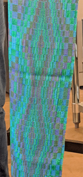 Ellen's three scarves were all woven on the same 20/2 teal cotton warp in Echo and Iris double weave patterns. The texture of the scarf on the left resulted from weaving with a colcolastic weft (lycra/20/2 cotton) which contracts when it's washed. The other two scarves had 20/2 silk wefts