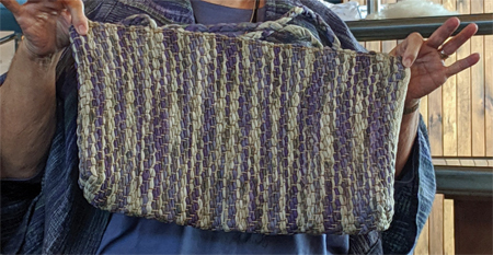 Margaret brought several items to show us, including this tote bag she fashioned using a rug warp. She wove the ends of the braided handles into the fabric while it was on the loom to secure them.