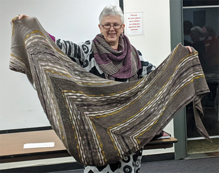 Shelby brought two wool shawls she had knit -- on the left in a striped pattern, on the right in a variety of lace stitches.