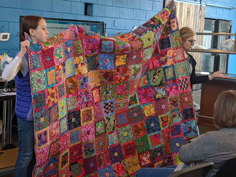 Amy's daughter helped hold up the quilts, including this richly patterned and lovely one.