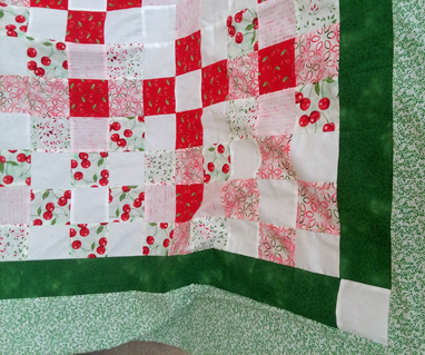 From Tammy: This queen size quilt is one of the things I have been working on. Only the top is done at this point. It is done in various cherry prints for the most part, in homage to the Cherry Festival in Traverse City, MI.